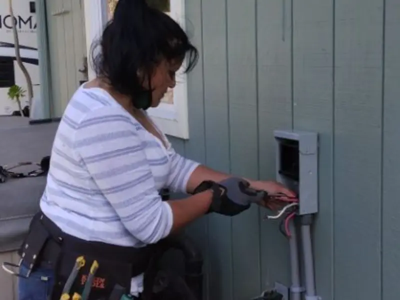 Licensed electrician wiring an exterior subpanel in Sparta
